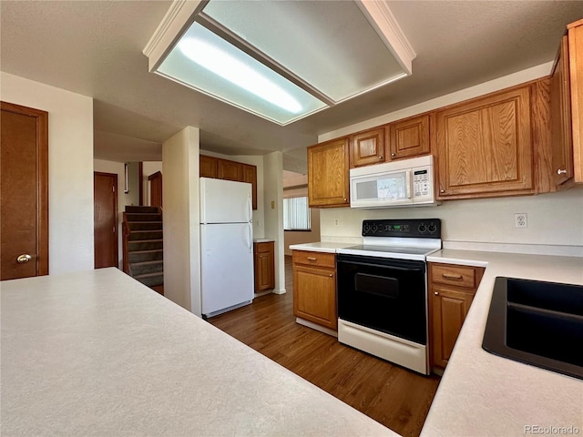 13191 Umatilla St, Denver, CO 80234 - kitchen with white appliances, dark wood-type flooring, light countertops, and brown cabinets