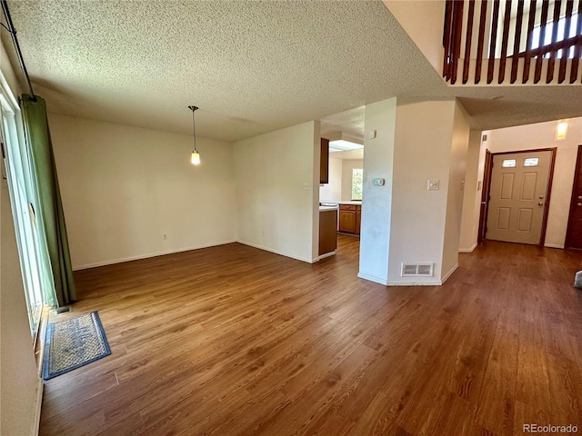 13191 Umatilla St, Denver, CO 80234 - unfurnished living room featuring wood finished floors and a textured ceiling