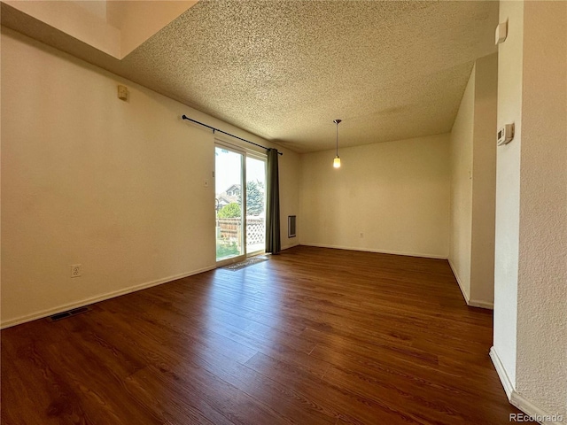 13191 Umatilla St, Denver, CO 80234 - unfurnished room featuring a textured ceiling and dark wood-style floors