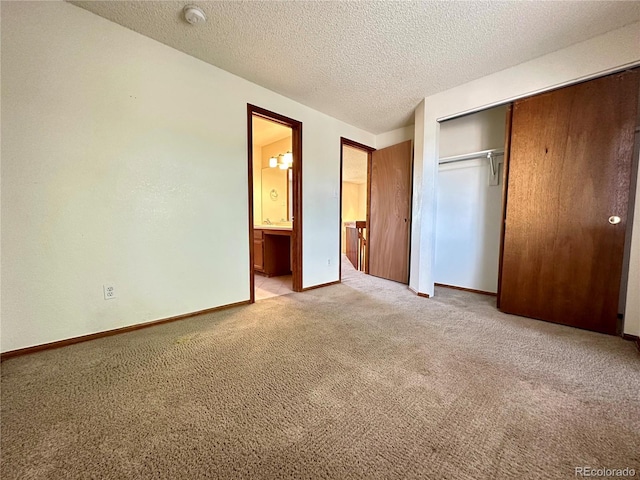 13191 Umatilla St, Denver, CO 80234 - unfurnished bedroom with light colored carpet, a closet, a textured ceiling, and ensuite bath