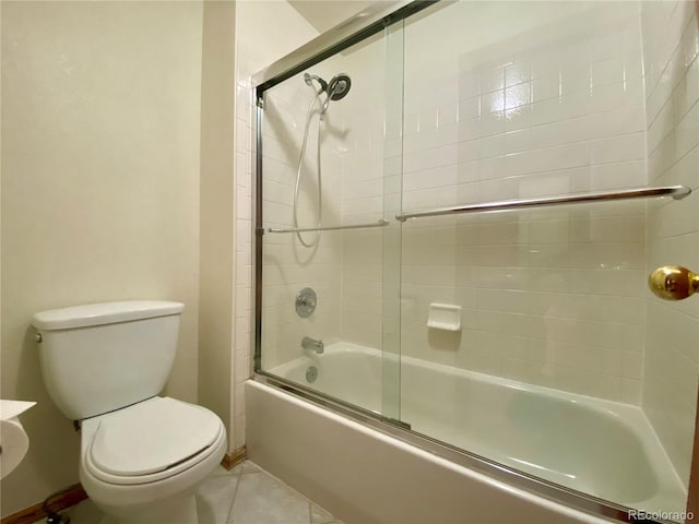 13191 Umatilla St, Denver, CO 80234 - full bathroom featuring bath / shower combo with glass door and tile patterned floors