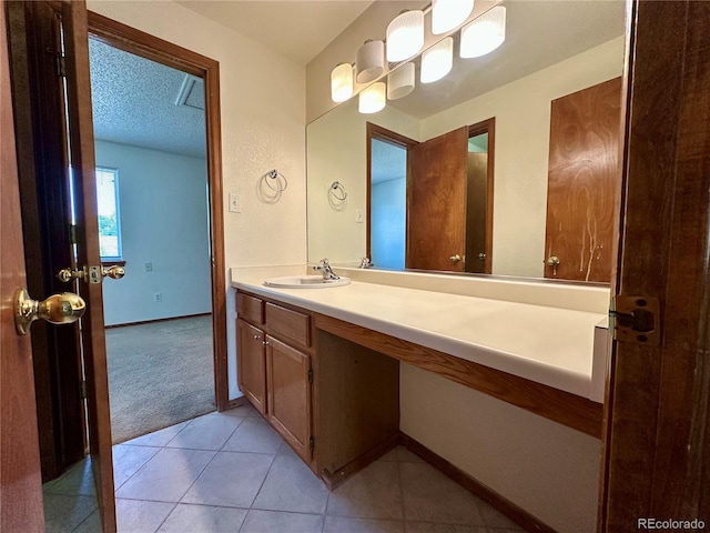 13191 Umatilla St, Denver, CO 80234 - bathroom featuring vanity, tile patterned flooring, and a textured ceiling