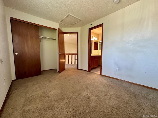 13191 Umatilla St, Denver, CO 80234 - unfurnished bedroom featuring light carpet, a closet, a textured ceiling, and attic access