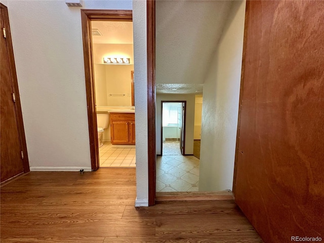 13191 Umatilla St, Denver, CO 80234 - hall with wood finished floors and a textured ceiling