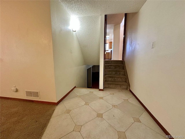 13191 Umatilla St, Denver, CO 80234 - staircase featuring a textured ceiling