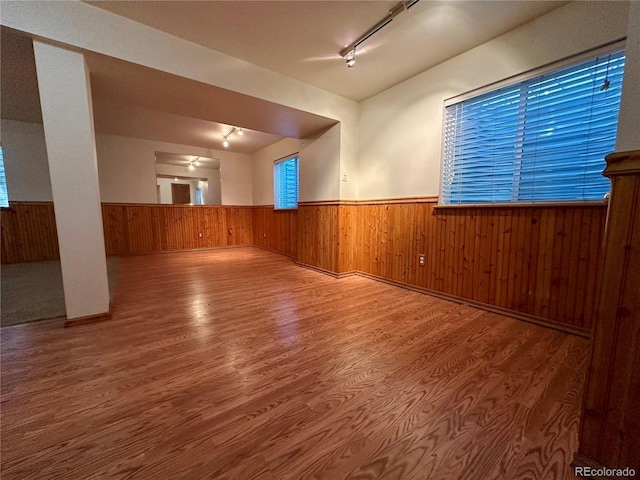 13191 Umatilla St, Denver, CO 80234 - unfurnished room featuring wainscoting, track lighting, wood walls, and wood finished floors