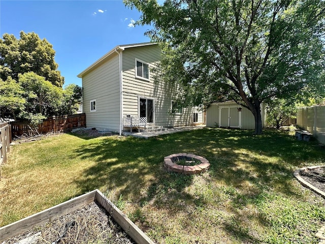 13191 Umatilla St, Denver, CO 80234 - fenced backyard featuring a shed and a fire pit