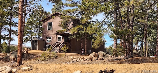 view of side of property with an outdoor structure and a storage unit
