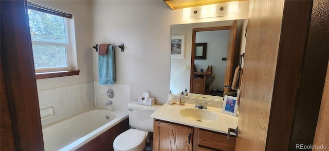 full bathroom featuring toilet, vanity, and a garden tub