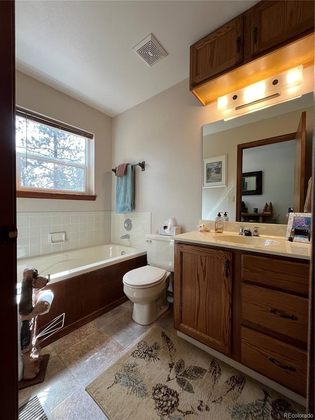 full bath featuring visible vents, a garden tub, toilet, and vanity