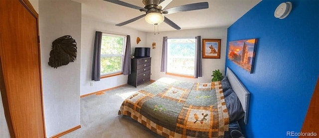 bedroom with baseboards, carpet flooring, and ceiling fan