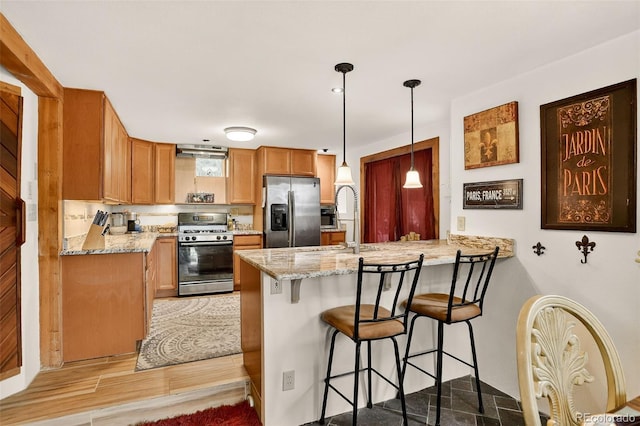 1575 York Gulch Rd, Idaho Springs, CO 80452 - kitchen with stainless steel appliances, a peninsula, a breakfast bar, and light stone countertops