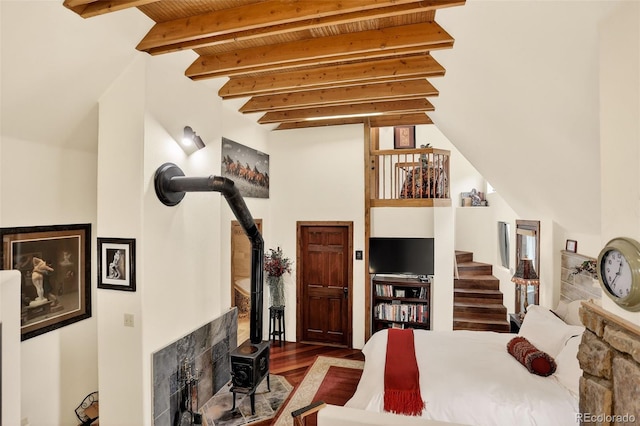 1575 York Gulch Rd, Idaho Springs, CO 80452 - bedroom featuring a wood stove, wood finished floors, and beamed ceiling
