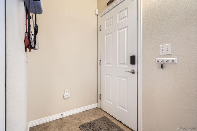 7292 S Blackhawk St Unit 2-204, Englewood, CO 80112 - doorway with baseboards and tile patterned flooring
