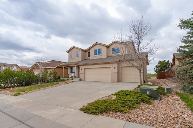 traditional home with stucco siding, a garage, and driveway