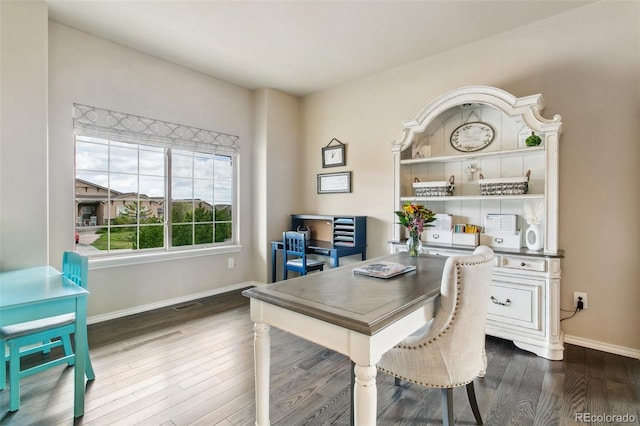 office area with dark wood-style floors and baseboards