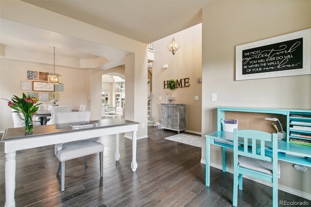 dining area with arched walkways, wood finished floors, baseboards, and a chandelier