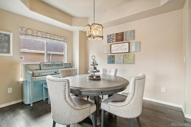 dining room with a chandelier, baseboards, and dark wood finished floors