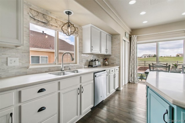 kitchen featuring dishwasher, a sink, decorative backsplash, white cabinets, and recessed lighting
