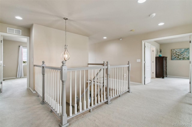 hallway featuring carpet floors, an upstairs landing, recessed lighting, and baseboards