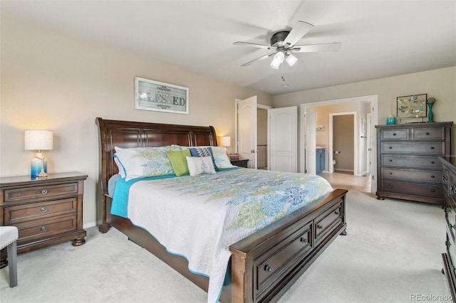 bedroom featuring light carpet, baseboards, ceiling fan, and connected bathroom