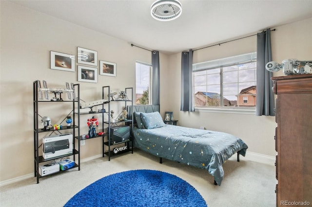 bedroom with carpet flooring and baseboards