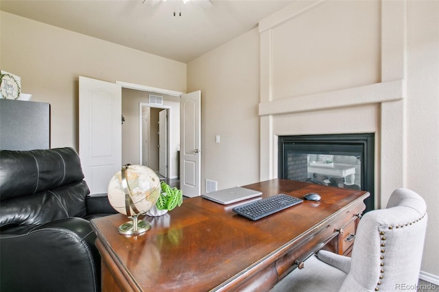 10416 Cedar Breaks Dr, Peyton, CO 80831 - office area featuring a multi sided fireplace