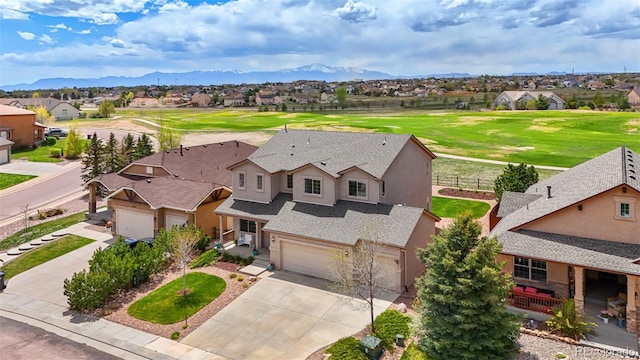 10416 Cedar Breaks Dr, Peyton, CO 80831 - aerial perspective of suburban area with mountains and a local golf course