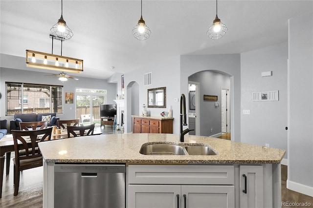 484 N Jamestown Way, Aurora, CO 80018 - kitchen featuring dishwasher, open floor plan, arched walkways, a sink, and a ceiling fan