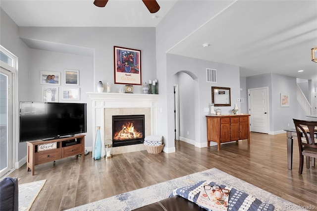 484 N Jamestown Way, Aurora, CO 80018 - living room with a ceiling fan, wood finished floors, arched walkways, a fireplace, and vaulted ceiling