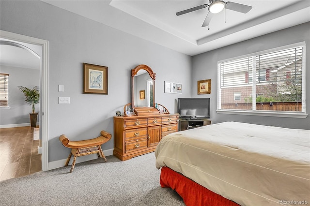 484 N Jamestown Way, Aurora, CO 80018 - carpeted bedroom featuring baseboards, a tray ceiling, and ceiling fan