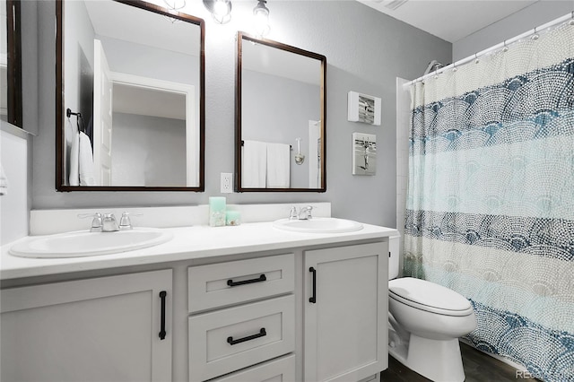 484 N Jamestown Way, Aurora, CO 80018 - full bathroom with double vanity, toilet, wood finished floors, and a shower with shower curtain
