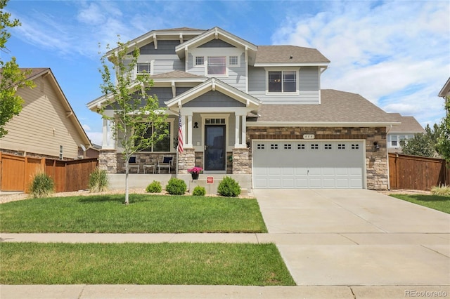 484 N Jamestown Way, Aurora, CO 80018 - craftsman-style house featuring driveway, stone siding, a garage, and a shingled roof