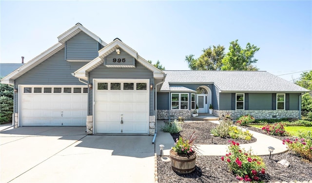 995 Chase St, Lakewood, CO 80214 - view of front of house featuring stone siding, an attached garage, concrete driveway, and roof with shingles