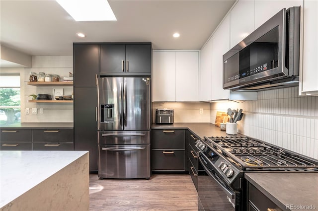 995 Chase St, Lakewood, CO 80214 - kitchen with appliances with stainless steel finishes, backsplash, white cabinets, modern cabinets, and recessed lighting