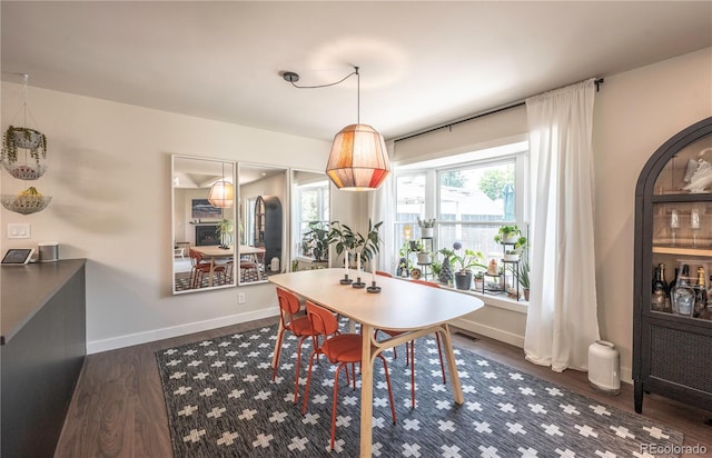 995 Chase St, Lakewood, CO 80214 - dining space with dark wood-style flooring and baseboards