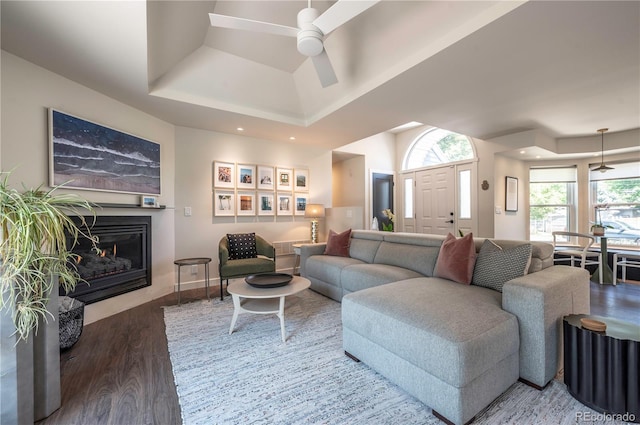 995 Chase St, Lakewood, CO 80214 - living area with wood finished floors, a ceiling fan, a glass covered fireplace, and a tray ceiling