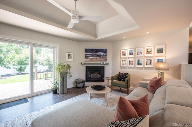995 Chase St, Lakewood, CO 80214 - living room featuring wood finished floors, ceiling fan, a fireplace with raised hearth, a raised ceiling, and recessed lighting