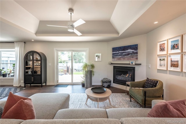 995 Chase St, Lakewood, CO 80214 - living room featuring a ceiling fan, a glass covered fireplace, wood finished floors, a raised ceiling, and recessed lighting