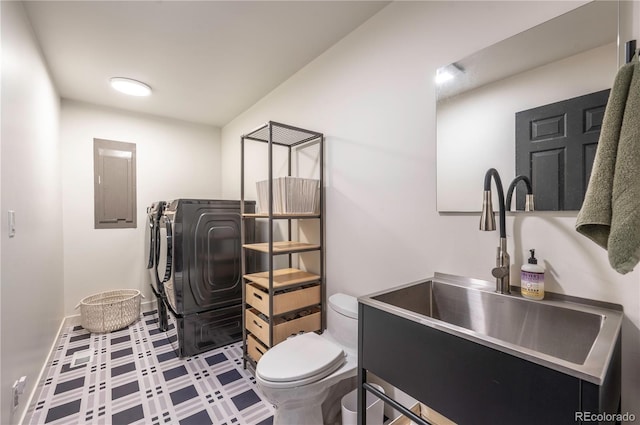 995 Chase St, Lakewood, CO 80214 - bathroom with washing machine and clothes dryer, electric panel, tile patterned floors, and vanity