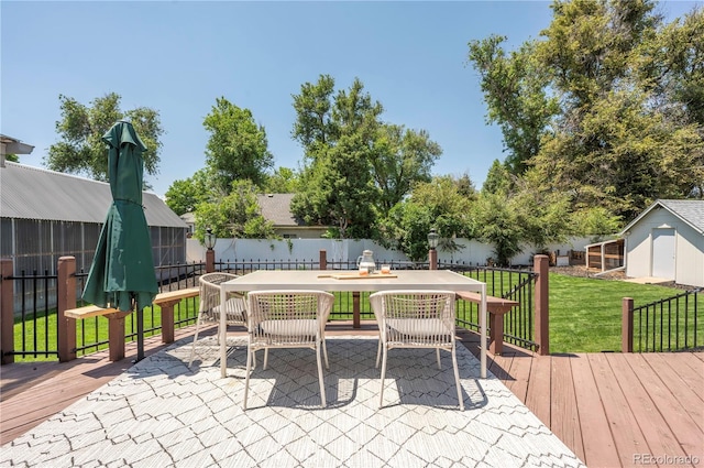 995 Chase St, Lakewood, CO 80214 - fenced backyard with a wooden deck, outdoor dining area, and a storage shed