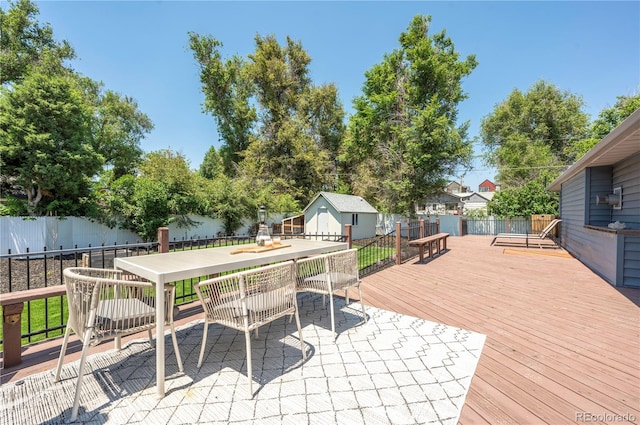 995 Chase St, Lakewood, CO 80214 - deck featuring a fenced backyard, outdoor dining area, and an outdoor structure