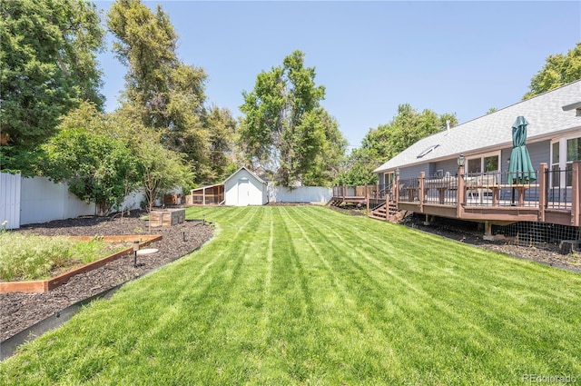 995 Chase St, Lakewood, CO 80214 - view of yard with a wooden deck, an outbuilding, and a garden