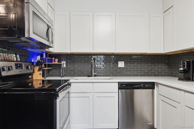 kitchen with white cabinets, appliances with stainless steel finishes, and sink