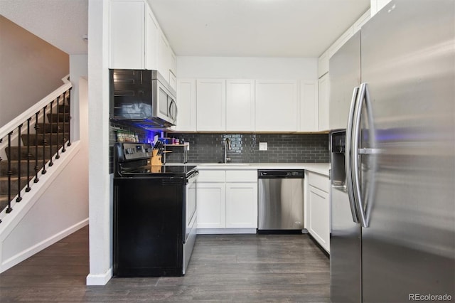 kitchen with appliances with stainless steel finishes, sink, dark hardwood / wood-style floors, and white cabinets