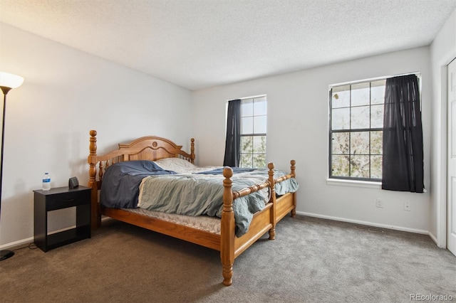 carpeted bedroom featuring a textured ceiling