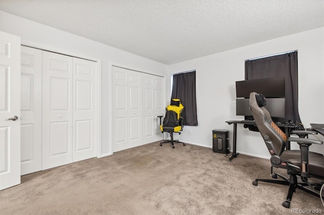 office featuring a textured ceiling and light colored carpet