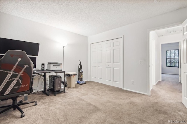 office featuring light colored carpet and a textured ceiling