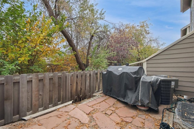 view of patio with area for grilling and cooling unit