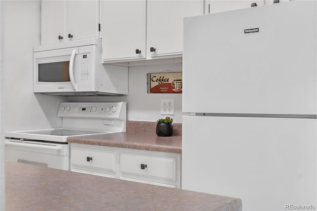 kitchen with white appliances and white cabinets